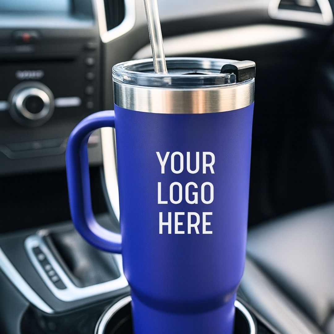 Royal blue 40 oz. tumbler with stainless steel band and clear lid, positioned in a car cup holder with sample logo text placeholder visible on the front.