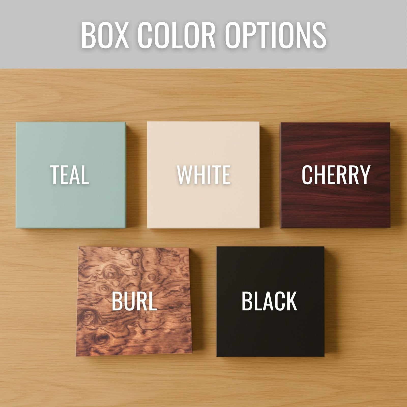 Five wooden box finishes displayed on light wood surface labeled Teal, White, Cherry, Burl, and Black