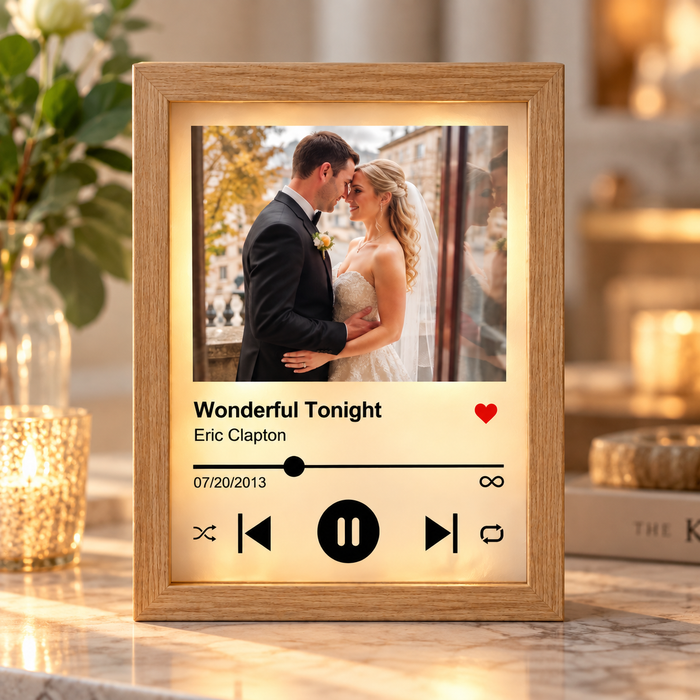 Personalized song plaque with a wedding photo, displaying "Wonderful Tonight" by Eric Clapton and the date 07/20/2013 on a warm LED glow display.