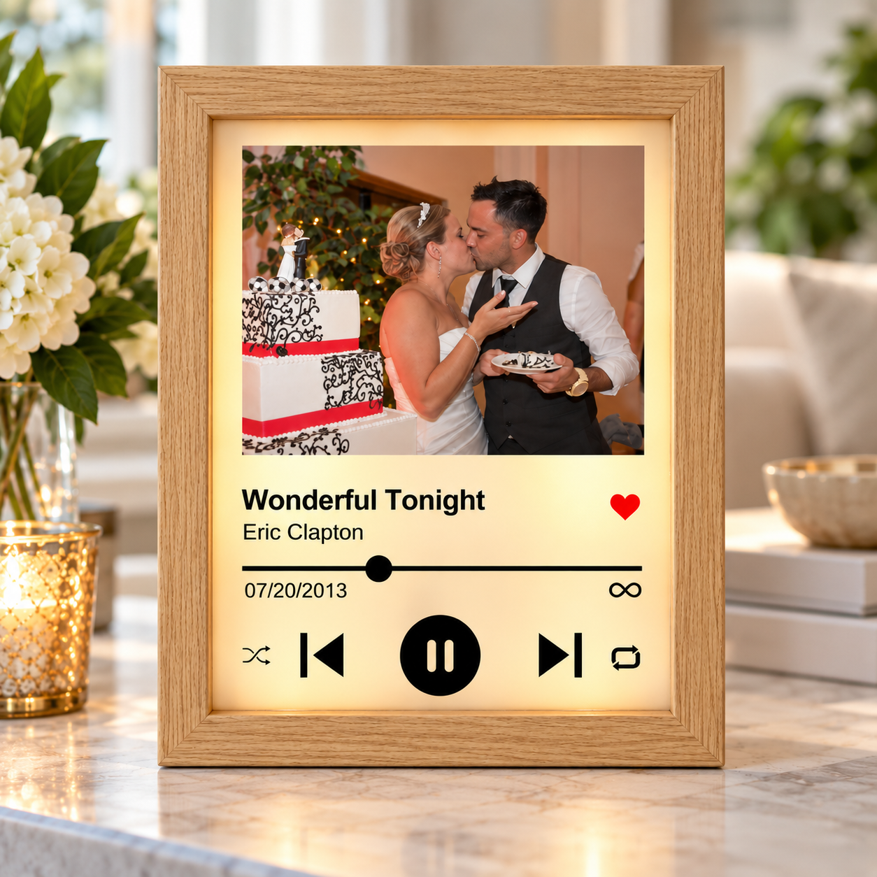 Personalized song plaque on a marble countertop near candles, displaying "Wonderful Tonight" by Eric Clapton and the date 07/20/2013.