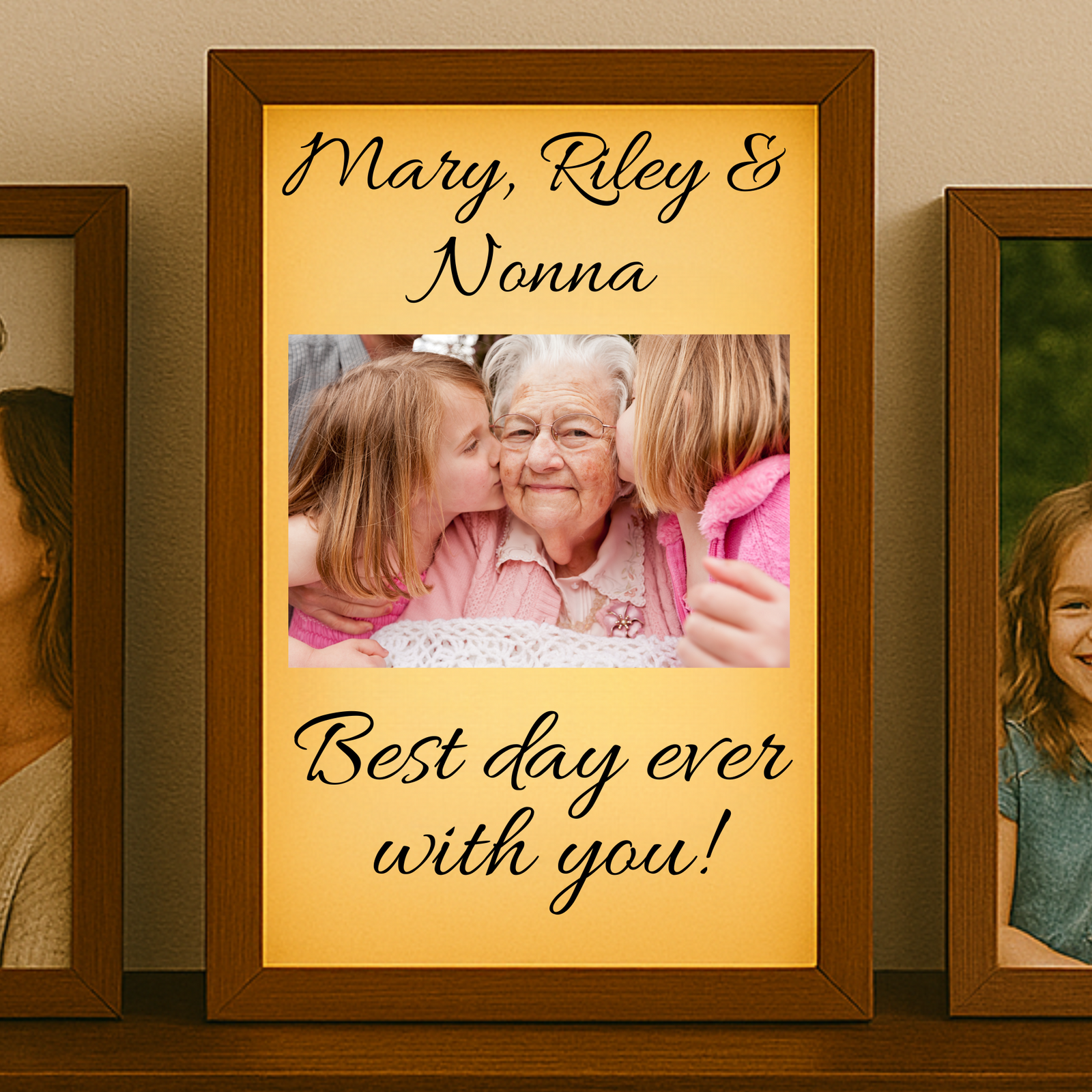 Framed photo of grandkids kissing an grand mother with text 'Mary, Riley & Nonna Best day ever with you!' on a shelf.