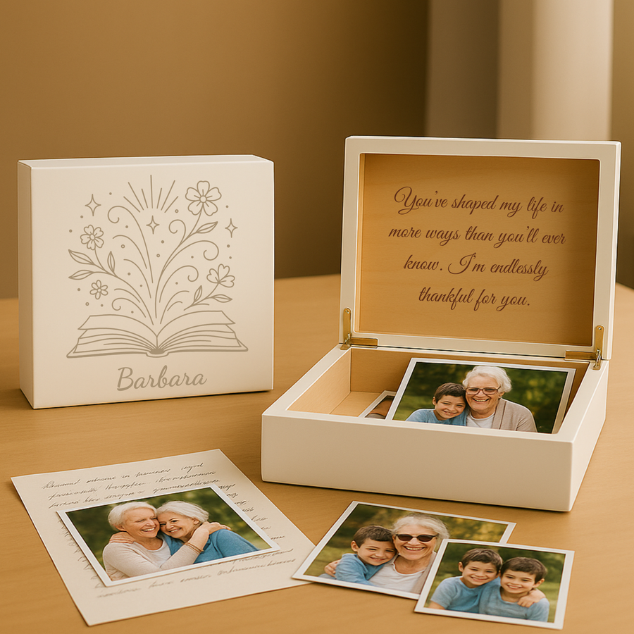 White wooden keepsake box with laser-engraved floral book design and sample name "Barbara," shown open displaying gold interior, engraved message, and photo storage alongside printed photos and greeting card.