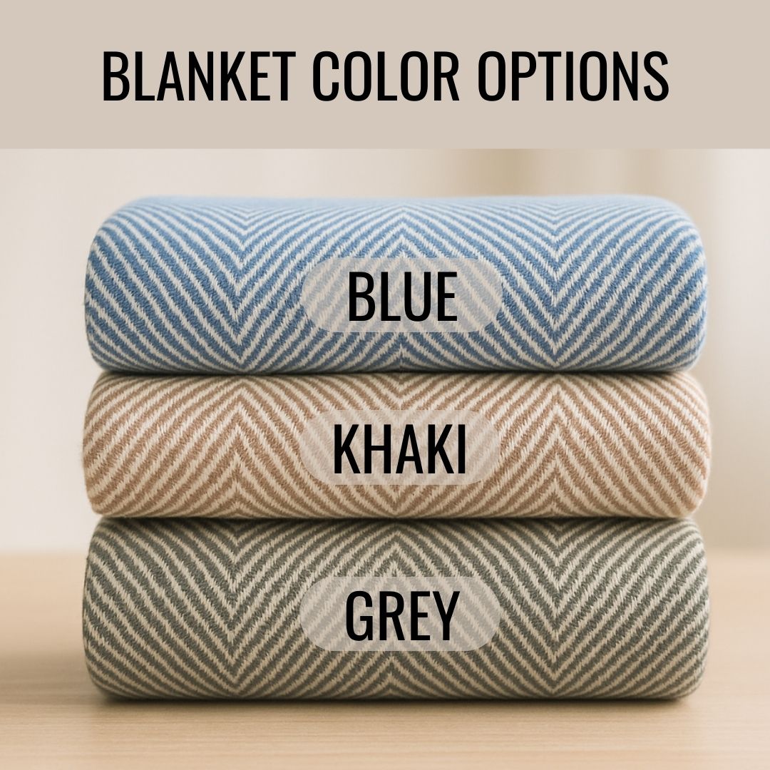 Three rolled blankets stacked displaying color options: blue with chevron pattern on top, khaki in middle, and grey on bottom