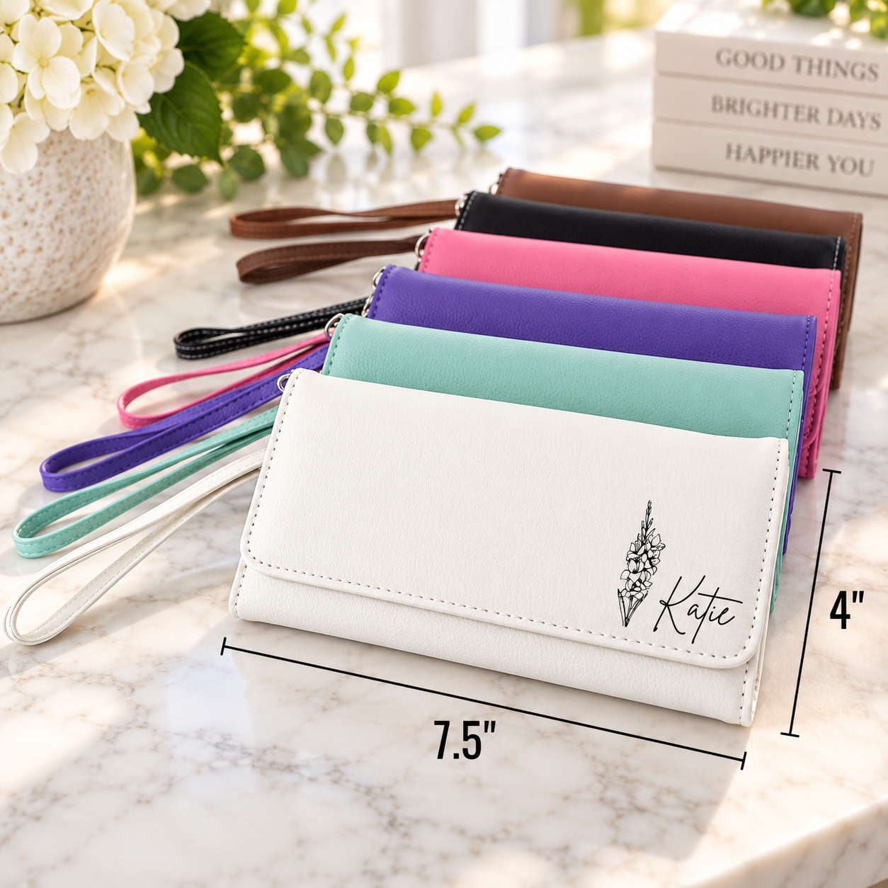 A stack of six long wallet or clutch cases in different colors, with the front white wallet shown prominently. The image includes dimension labels showing 7.