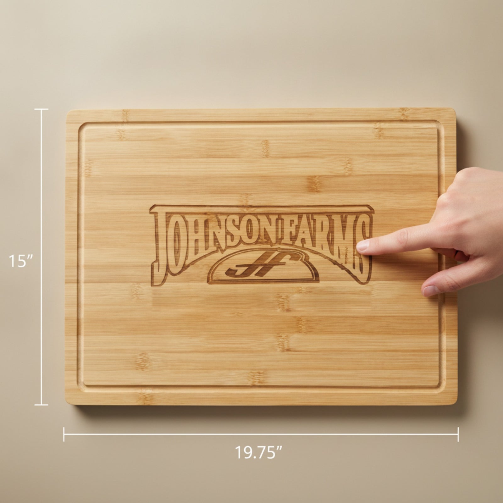 Large 19.75 by 15 inch custom logo cutting board engraved with a sample farm business logo, with a hand pointing at the logo and the dimensions marked