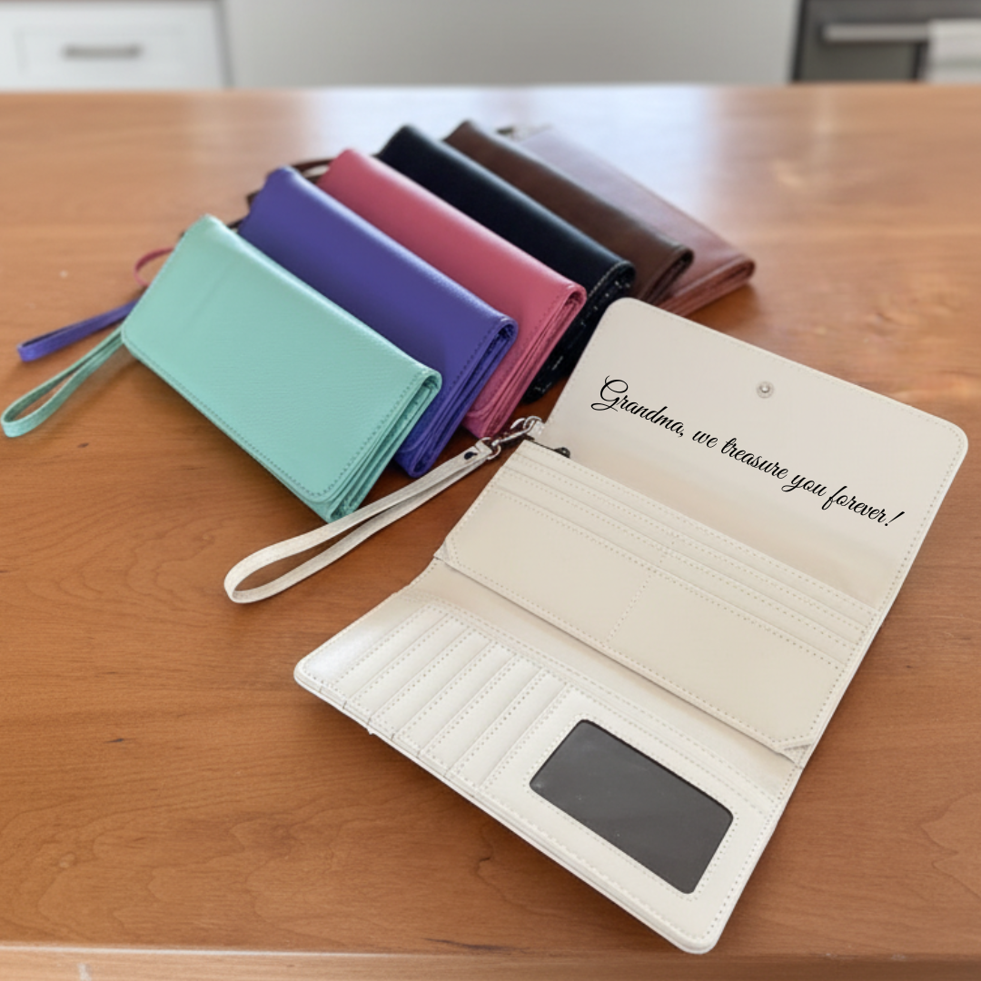 Cream wristlet open to show card slots and ID window with a message to Grandma engraved inside the flap, alongside other colour options.