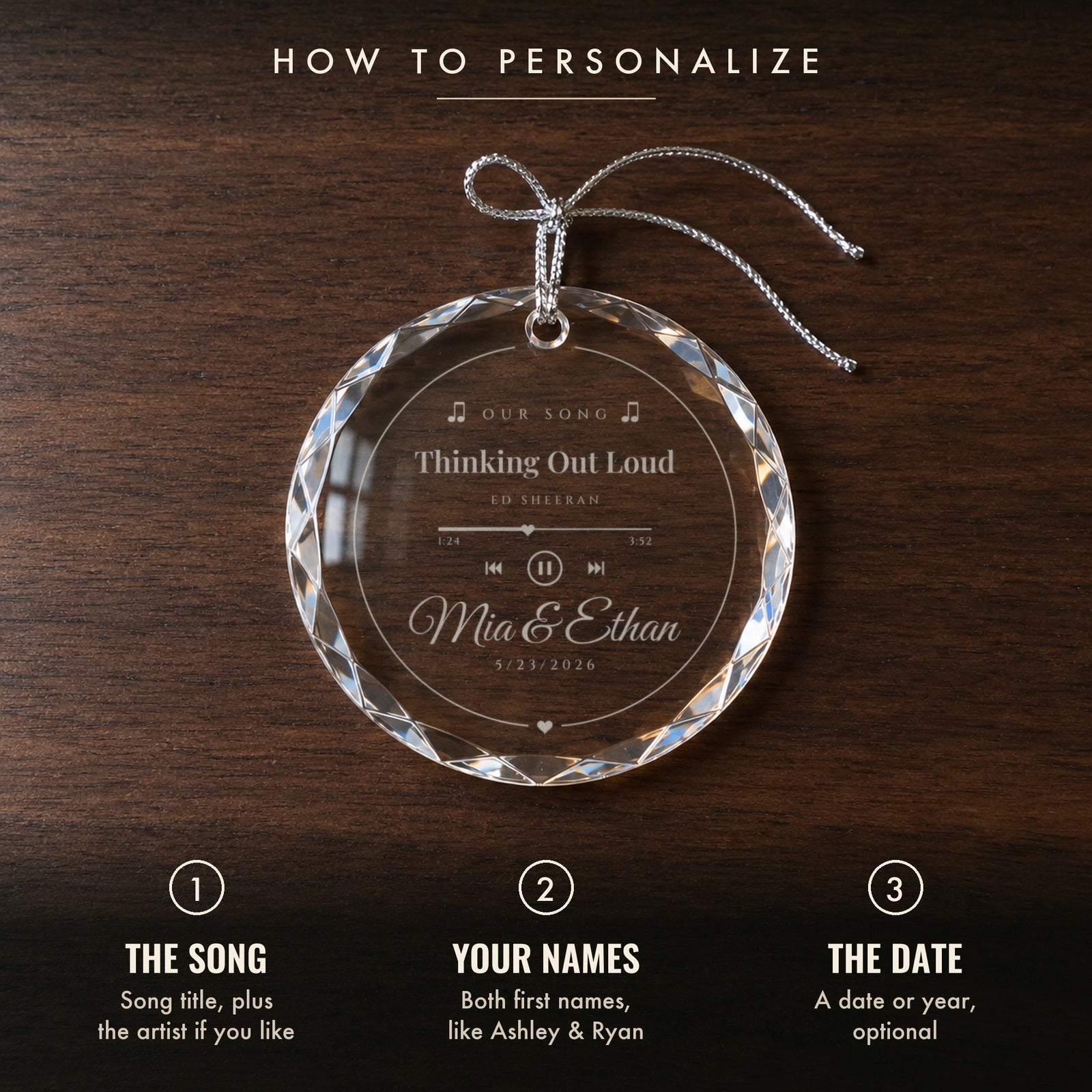 How to personalize the Our Song ornament: 1 the song and artist, 2 your names, 3 an optional date, shown on a walnut table with Mia & Ethan