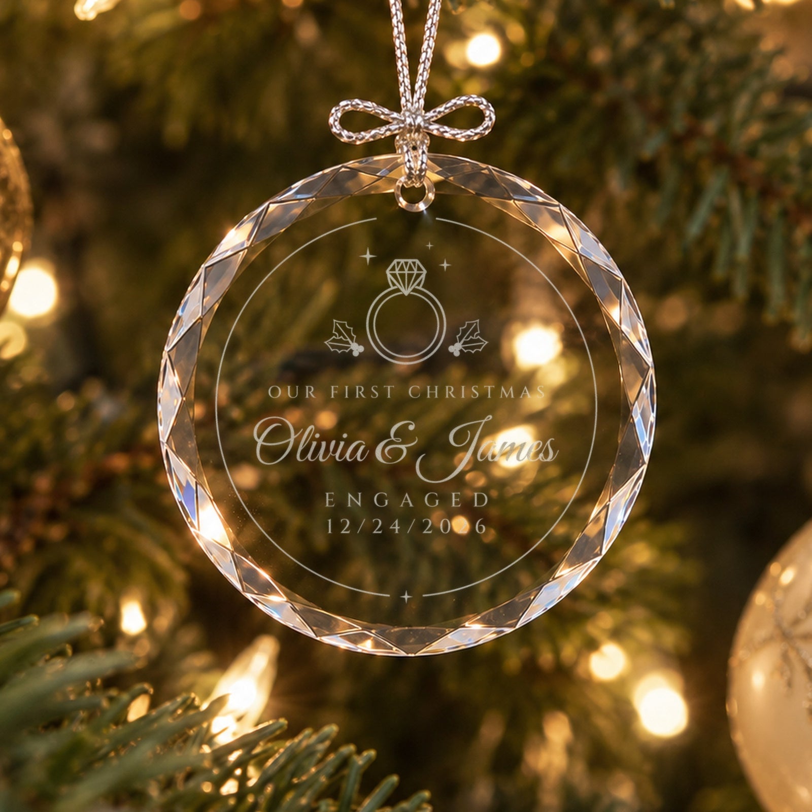 Personalized engagement ornament in faceted glass on a lit Christmas tree, engraved with a diamond ring, holly, Olivia & James, ENGAGED 12/24/2026