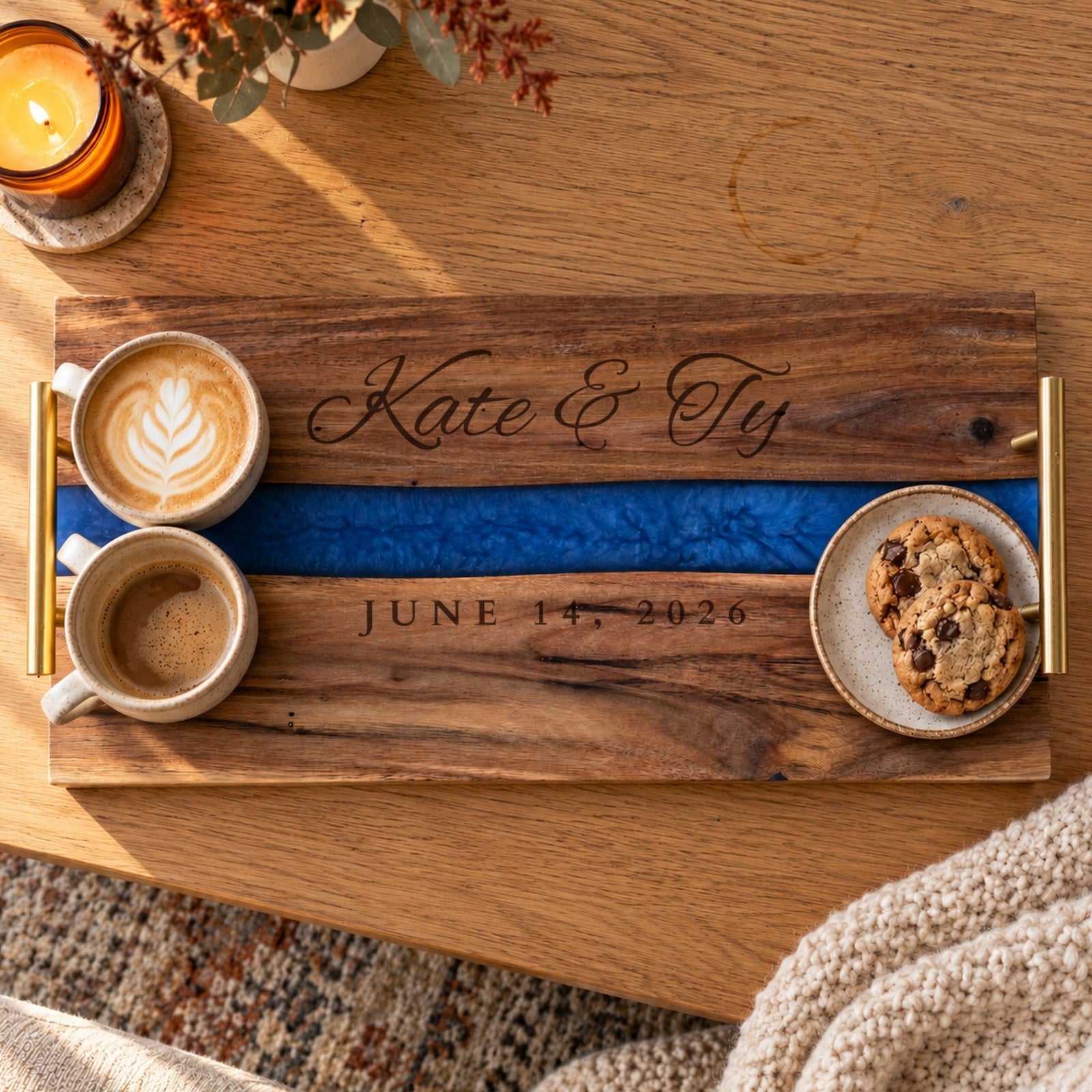 Personalized acacia and blue resin serving tray engraved Kate & Ty and June 14, 2026, holding two lattes and cookies on a coffee table, a wedding gift for a couple