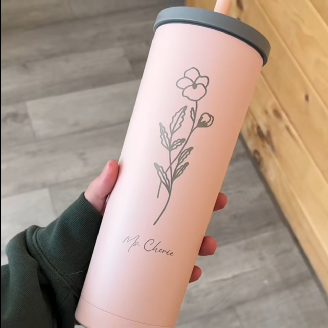 Personalized skinny tumbler with birth flower design and custom name engraving.