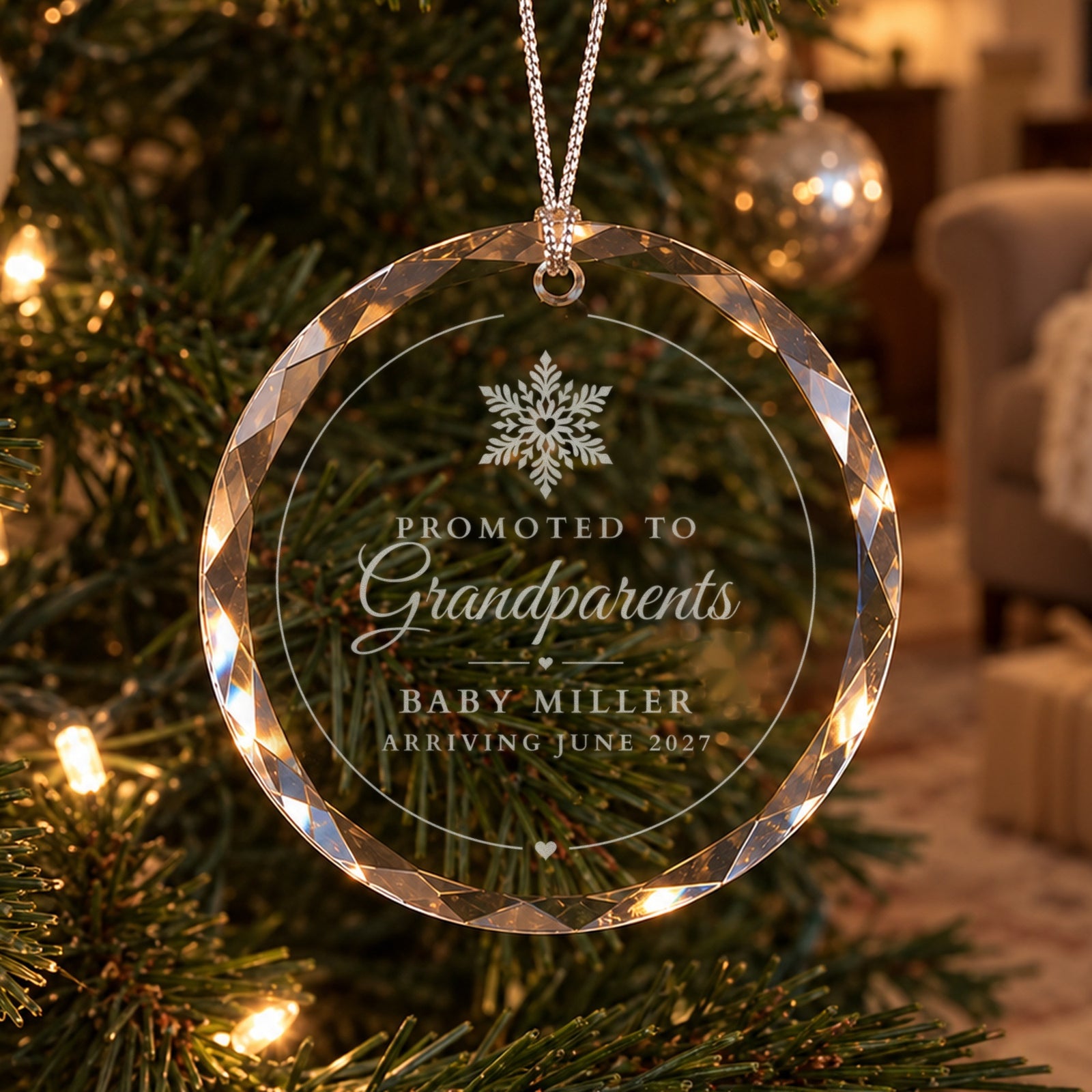 Promoted to Grandparents ornament in clear faceted glass on a lit Christmas tree, engraved with a snowflake, Baby Miller and Arriving June 2027
