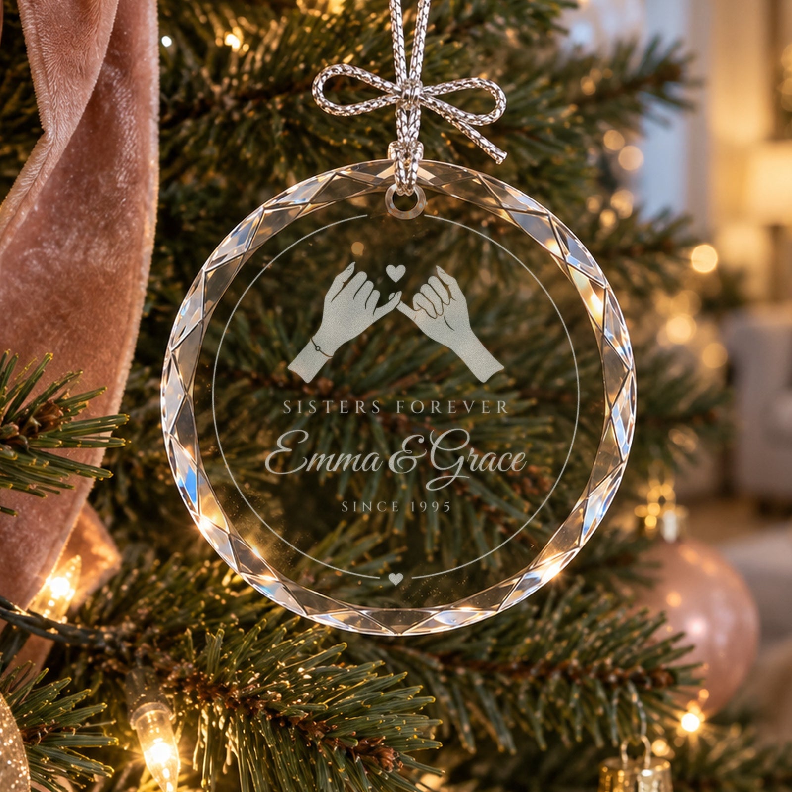 Personalized sister ornament in faceted glass on a blush and gold Christmas tree, engraved with a pinky promise, Sisters Forever, Emma & Grace
