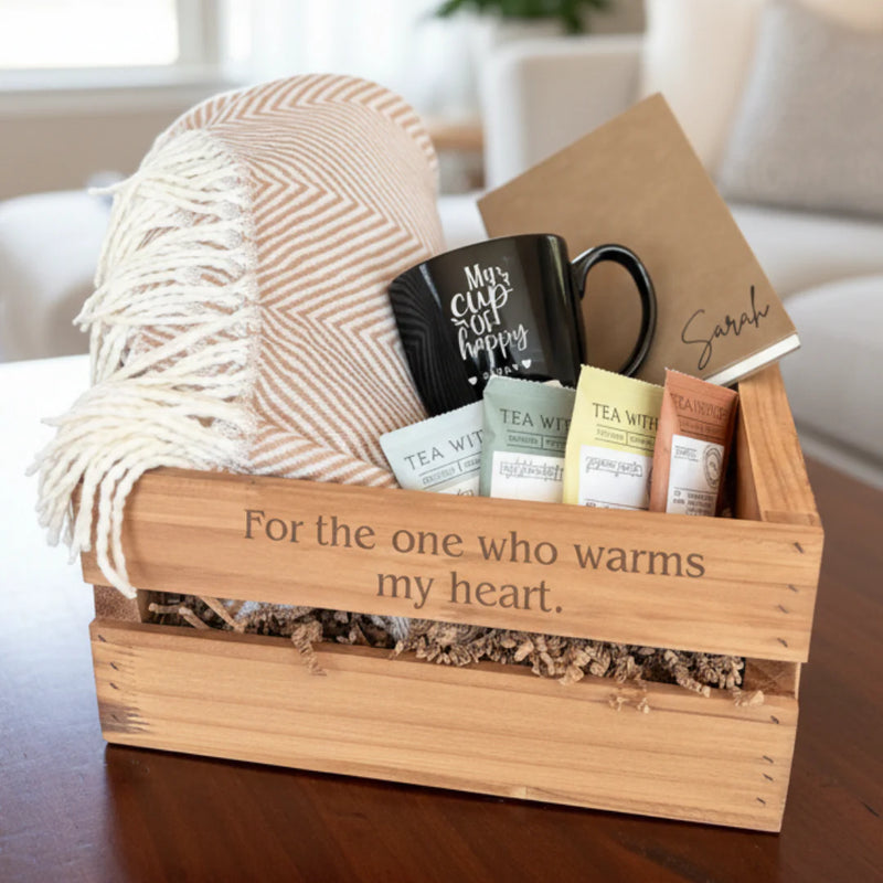 Custom gift set in wooden crate with blanket, mug, tea, and journal
