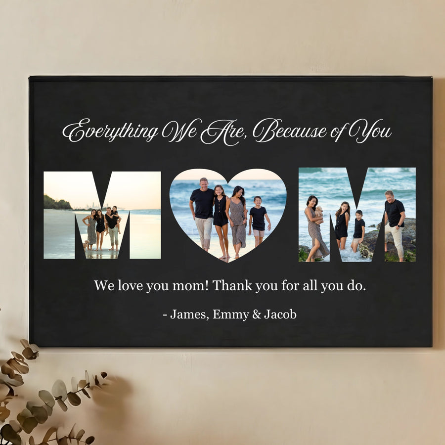 Black wall sign with three photo cutouts spelling MOM, featuring family beach photos, script text reading "Everything We Are, Because of You," and sample names "James, Emmy & Jacob" at bottom