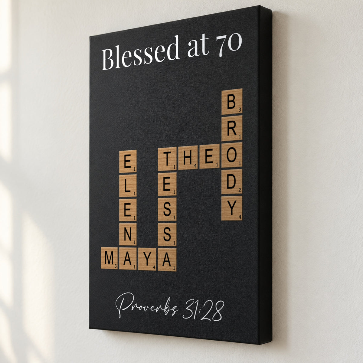 Angled close view of a Blessed at 70 crossword sign with Proverbs 31:28, showing the 1.5 inch deep edge and family names printed flat