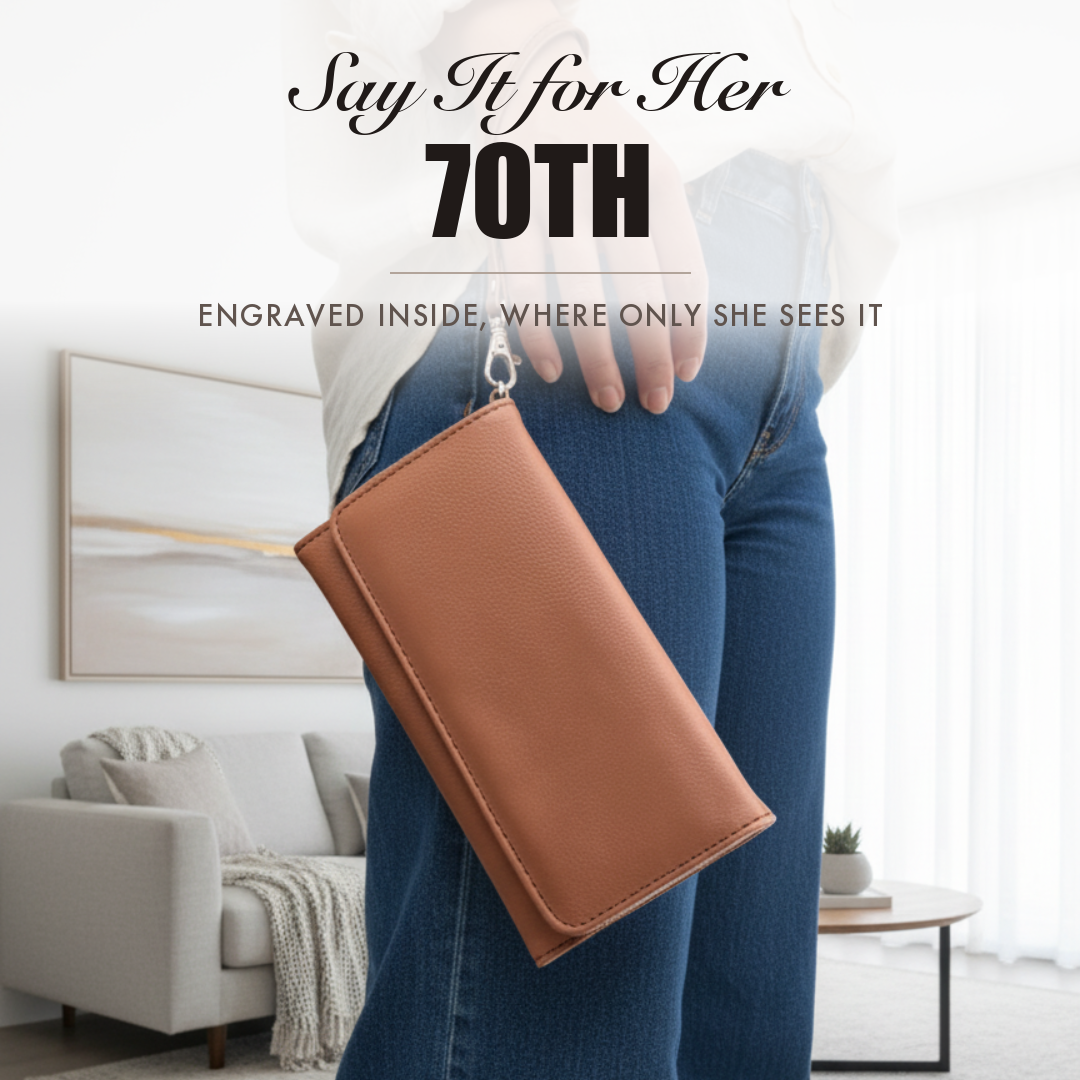 Brown faux leather wristlet held by a woman, captioned Say It for Her 70th, shown as a personalized 70th birthday gift.