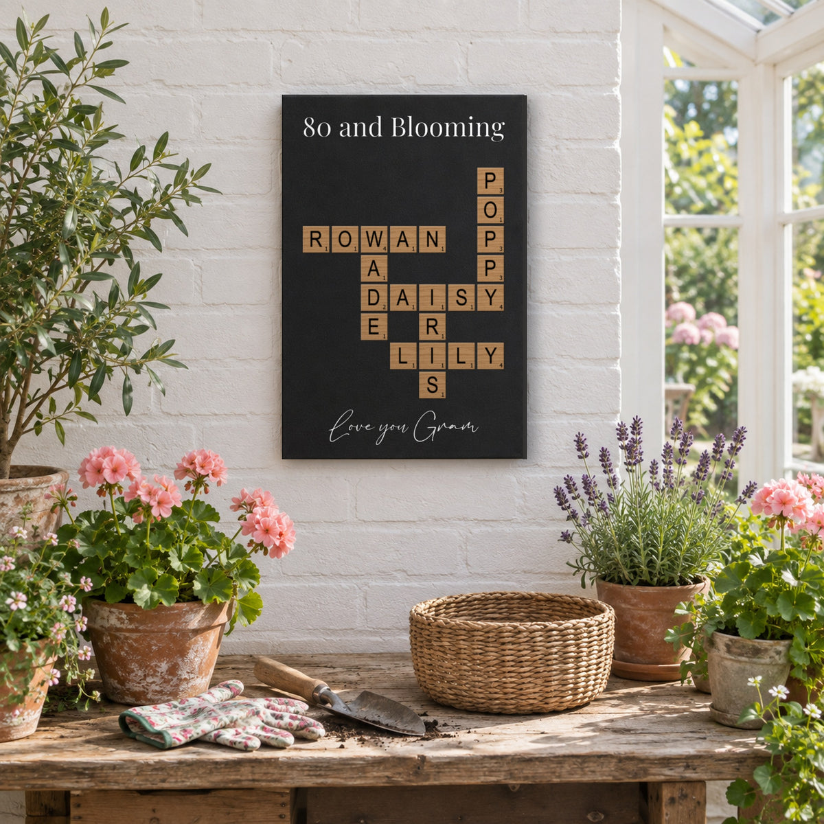 80th birthday gift for a grandma who loves to garden: an 80 and Blooming crossword sign above a potting table with geraniums