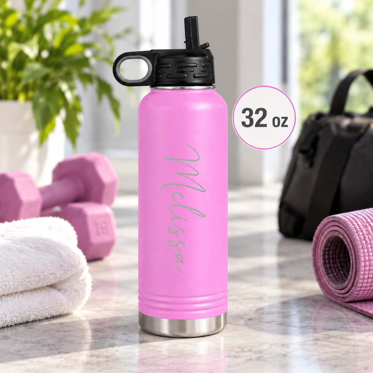 Light blue insulated water bottle laser engraved with the name Kaleigh in script, outdoors on a wooden table.