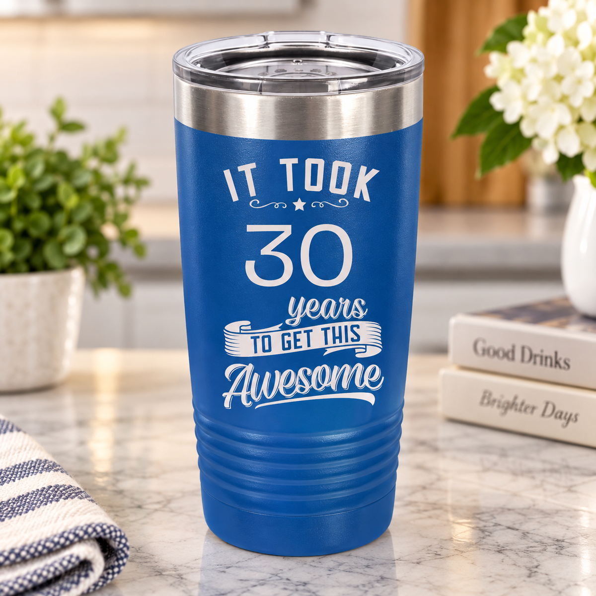 Blue stainless steel tumbler with engraved sample message: "It took 30 years to get this Awesome" with decorative flourishes and star.