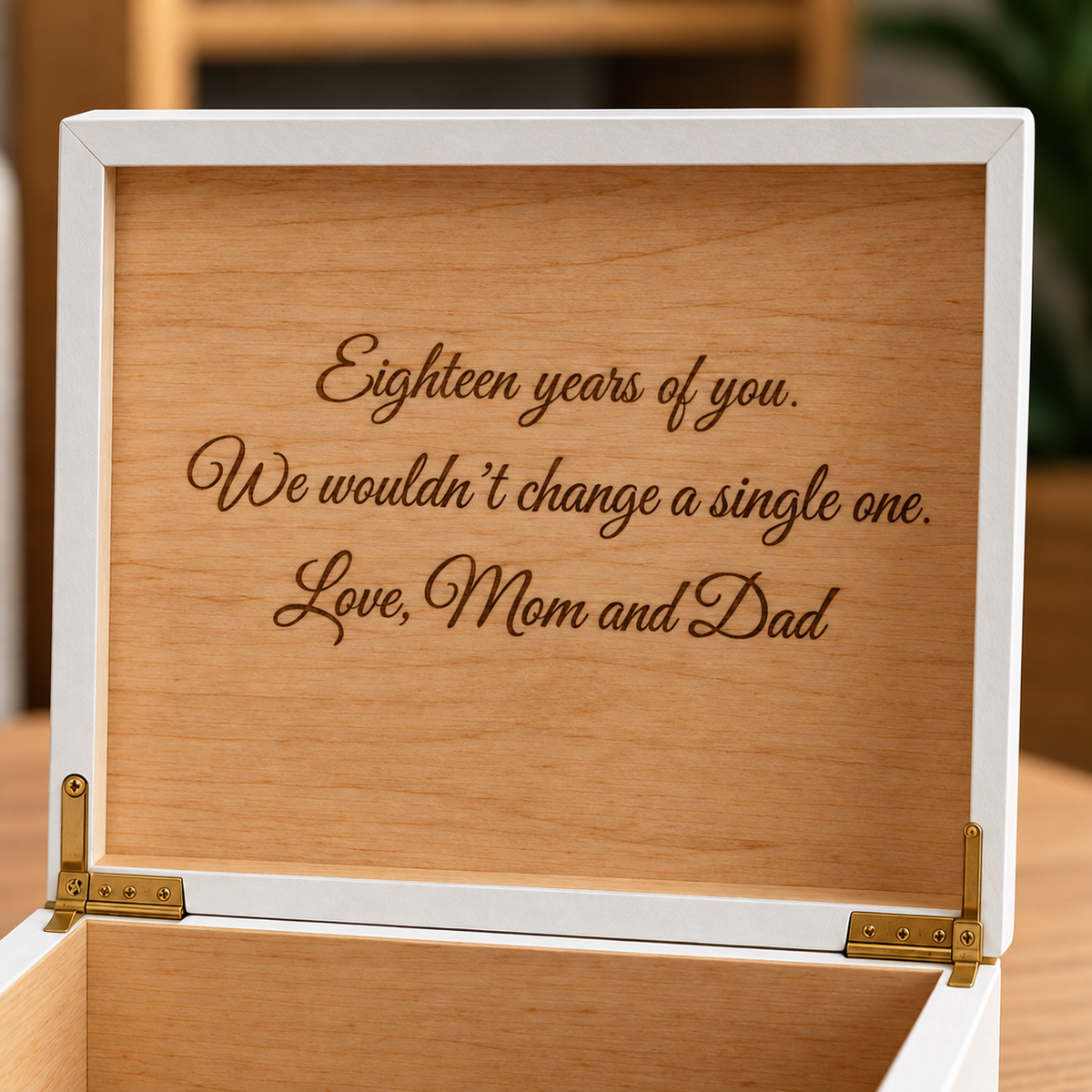 White wooden keepsake box with tan wood interior engraved with sample text: "Eighteen years of you. We wouldn't change a single one. Love, Mom and Dad