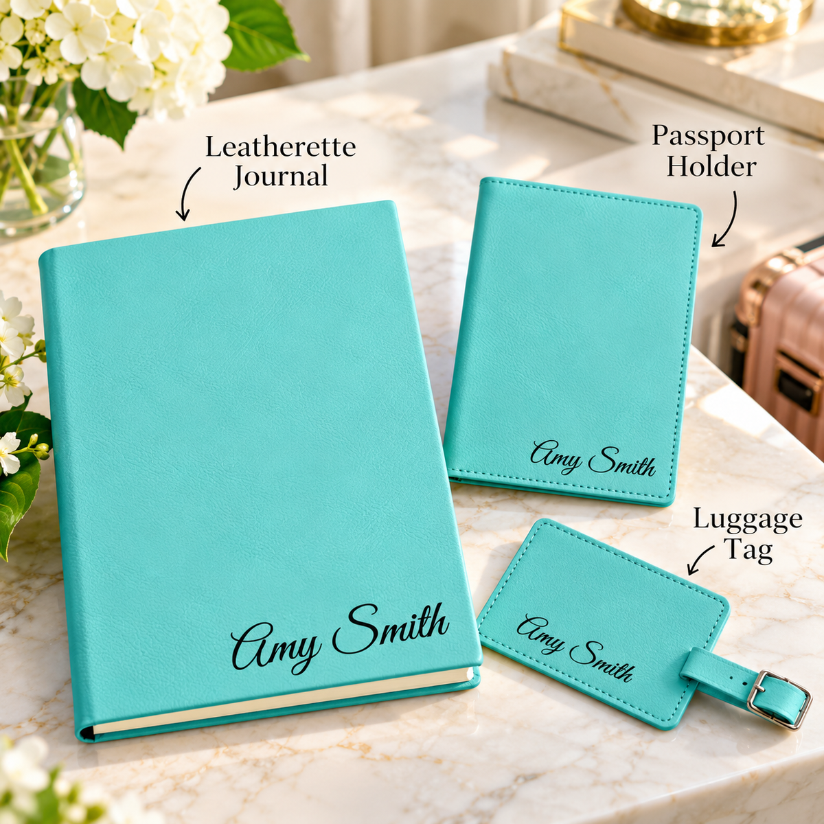 Teal leatherette journal, passport holder, and luggage tag from the personalized travel gift set, each labeled and engraved with the name Amy Smith.
