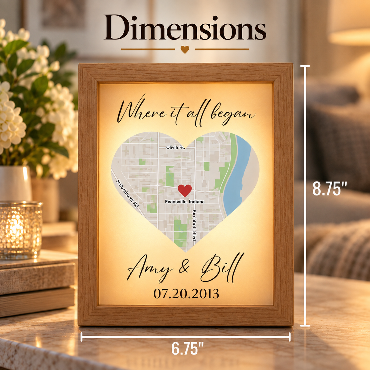 Framed wood map with sample engraving "Where it all began" with names "Amy &amp; Bell" and date 07.20.2013, showing Evansville, Indiana location marked with red heart.