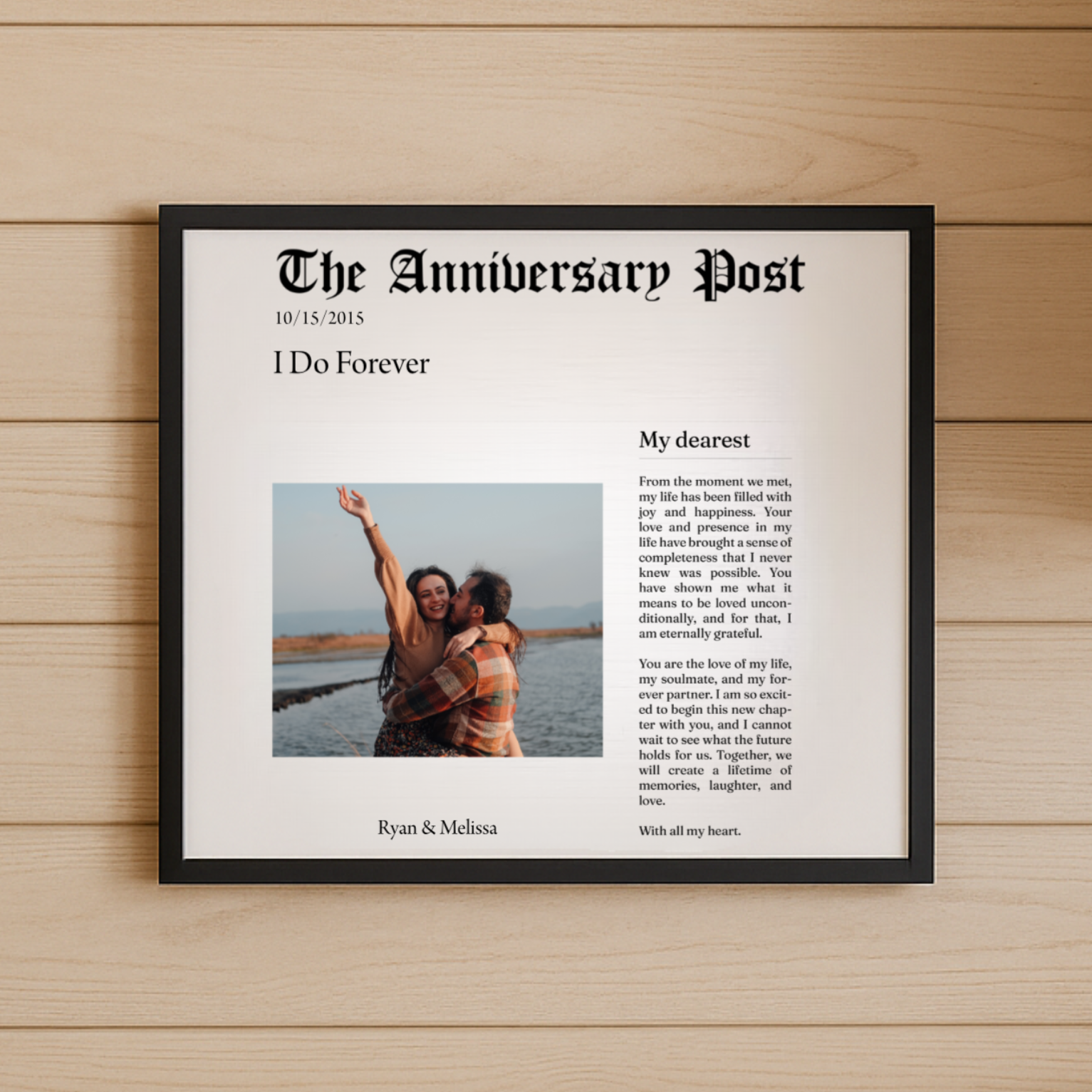 Framed anniversary gift on a wooden wall with a couple's photo and text.
