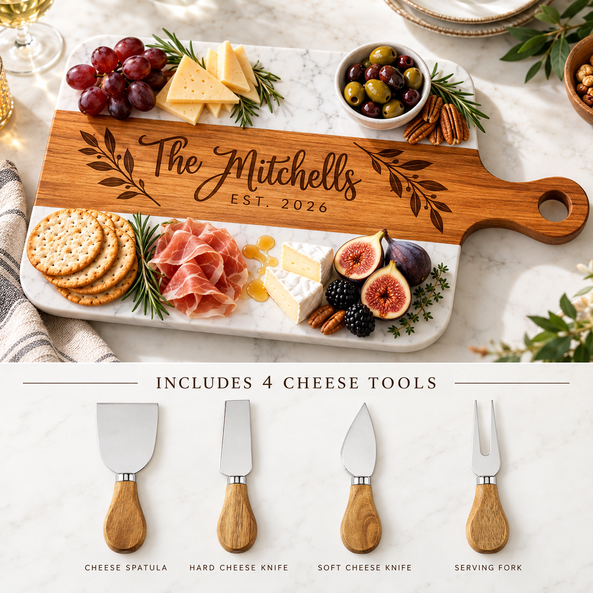 Personalized wooden cheese board set shown with food styling on a marble surface, plus a bottom panel listing the included cheese tools: spatula, hard cheese knife, soft cheese knife, and serving fork. The board is engraved with the name The Mitchells and EST.