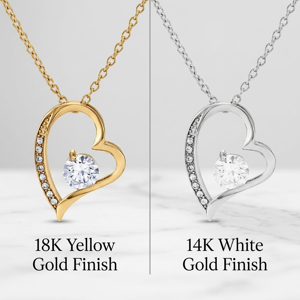 Side-by-side comparison of the open heart pendant necklace in 18k yellow gold finish and 14k white gold finish, each set with a round cubic zirconia stone.