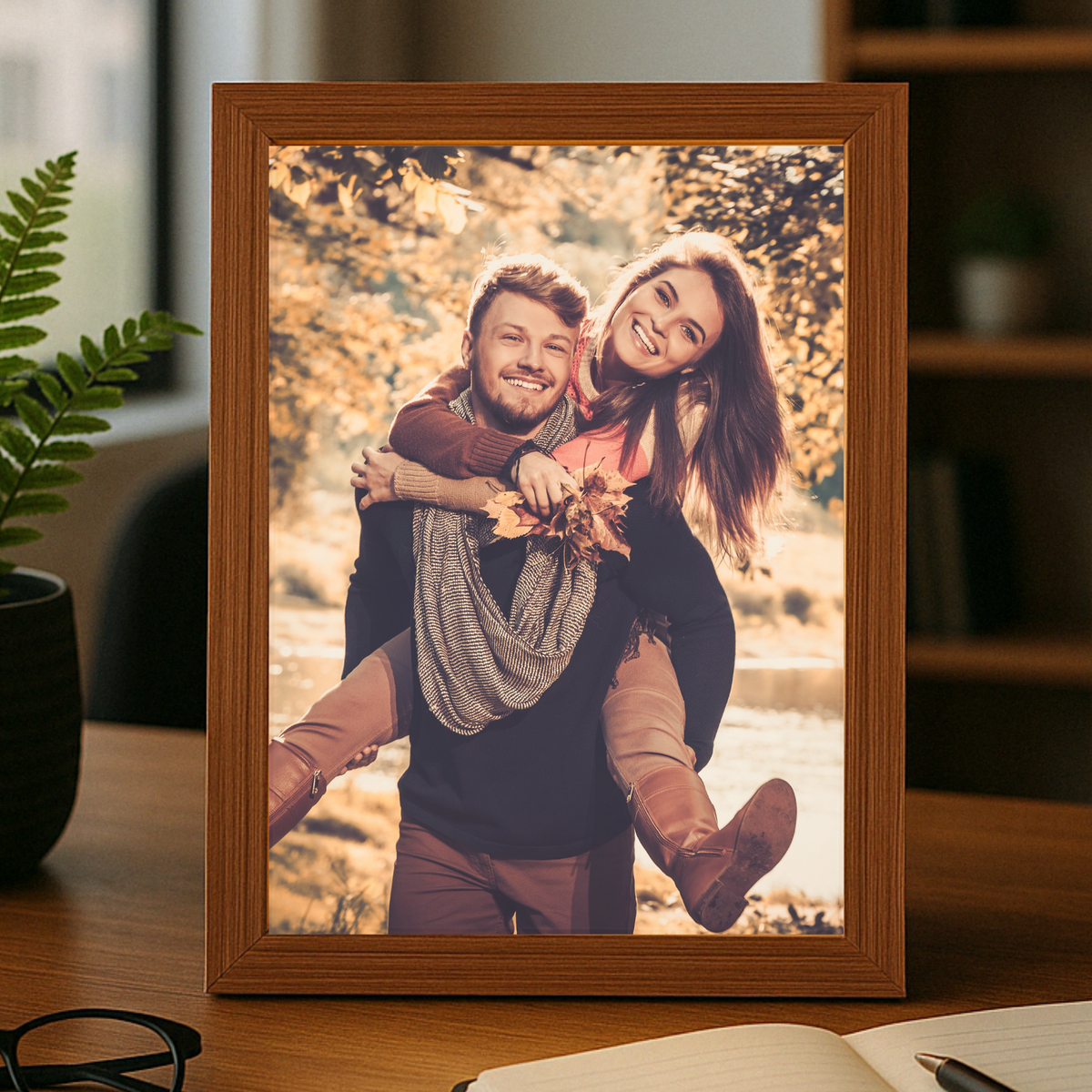 Wooden photo frame with a couple&#39;s picture on a desk
