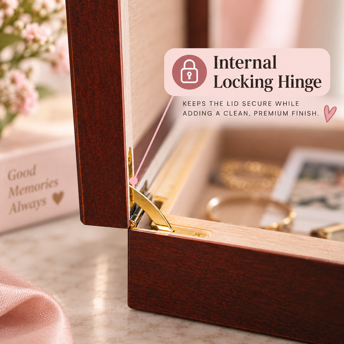Close-up of the internal locking hinge on a cherry wood keepsake box, holding the lid open above the light Spanish cedar lining inside
