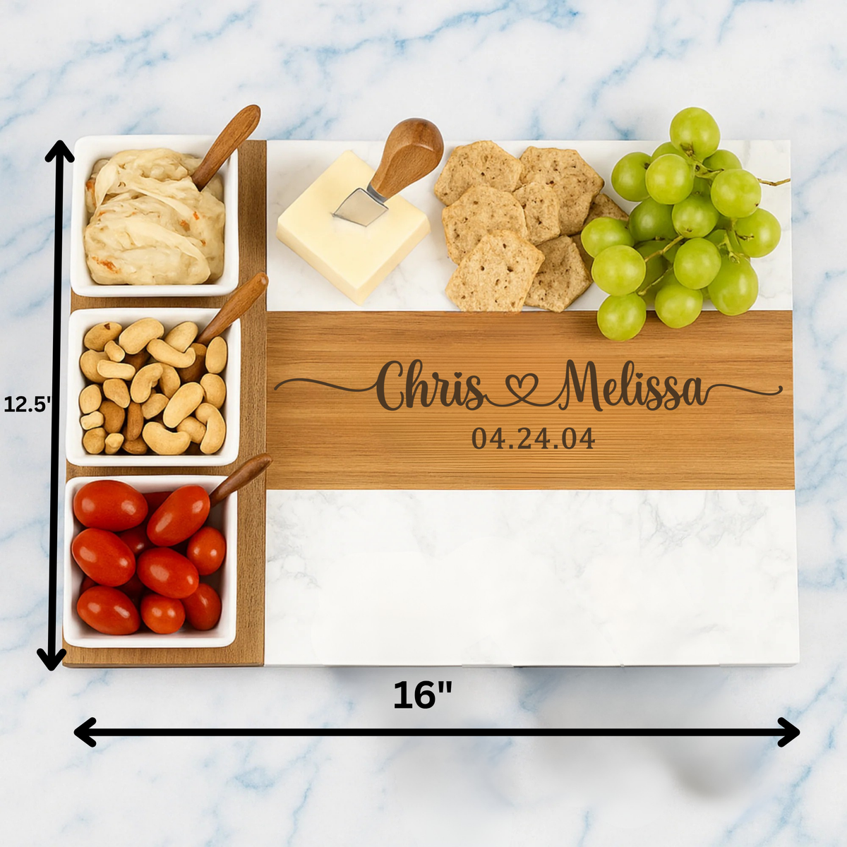 Close view of the engraved script on a personalized couples charcuterie board showing two names, a heart and a special date.