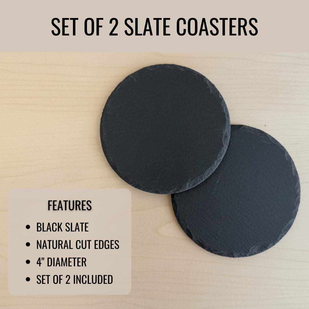 Pair of round black slate coasters with natural cut edges, 4 inches in diameter, displayed on a light wood surface