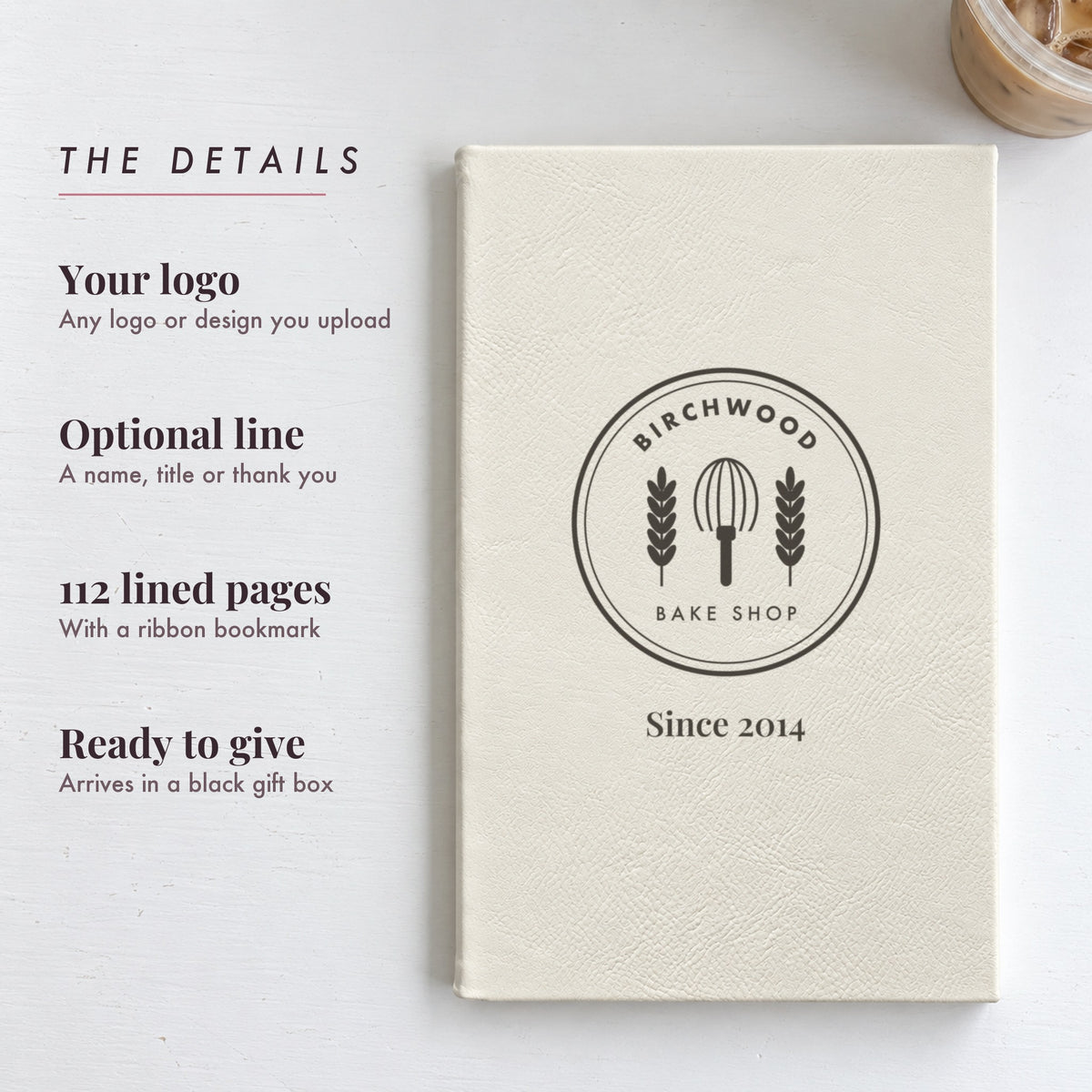 Details of the custom logo journal: your logo engraved on the cover, an optional line, 112 lined pages and a black gift box, shown with a bake shop logo and Since 2014