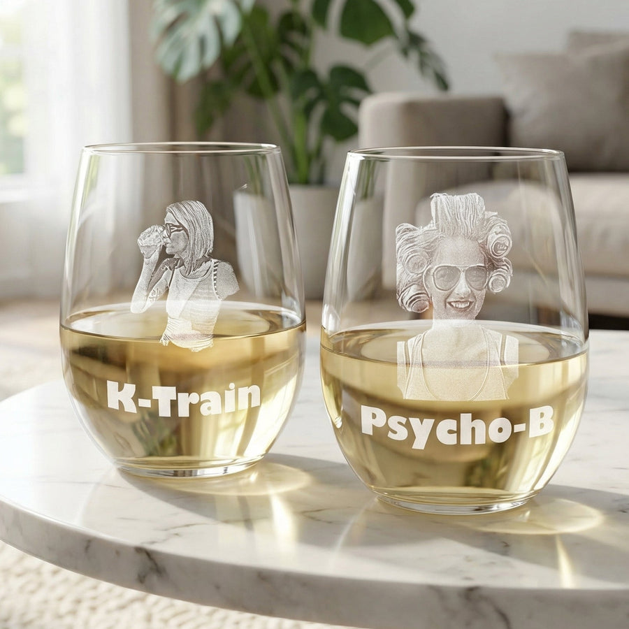 Pair of 17-ounce wine glasses with engraved sample photos and text reading "K-Train" and "Psycho-B", filled with white wine, displayed on marble surface.