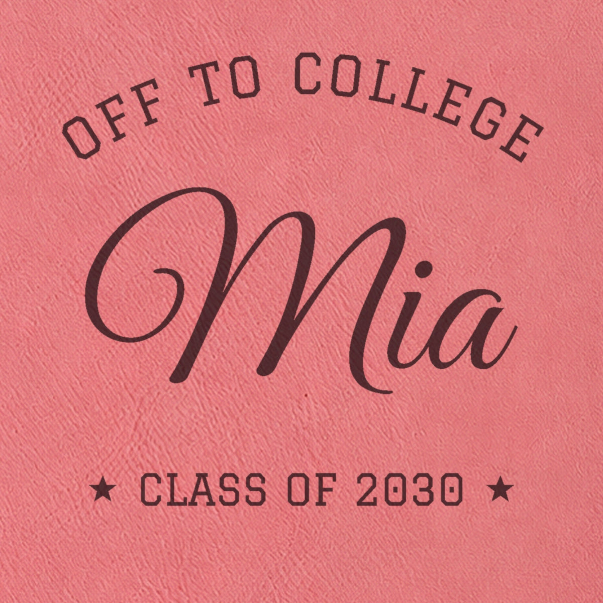 Close-up of the engraving on the pink college journal: Off to College arched over Mia in big script, with Class of 2030 between two stars