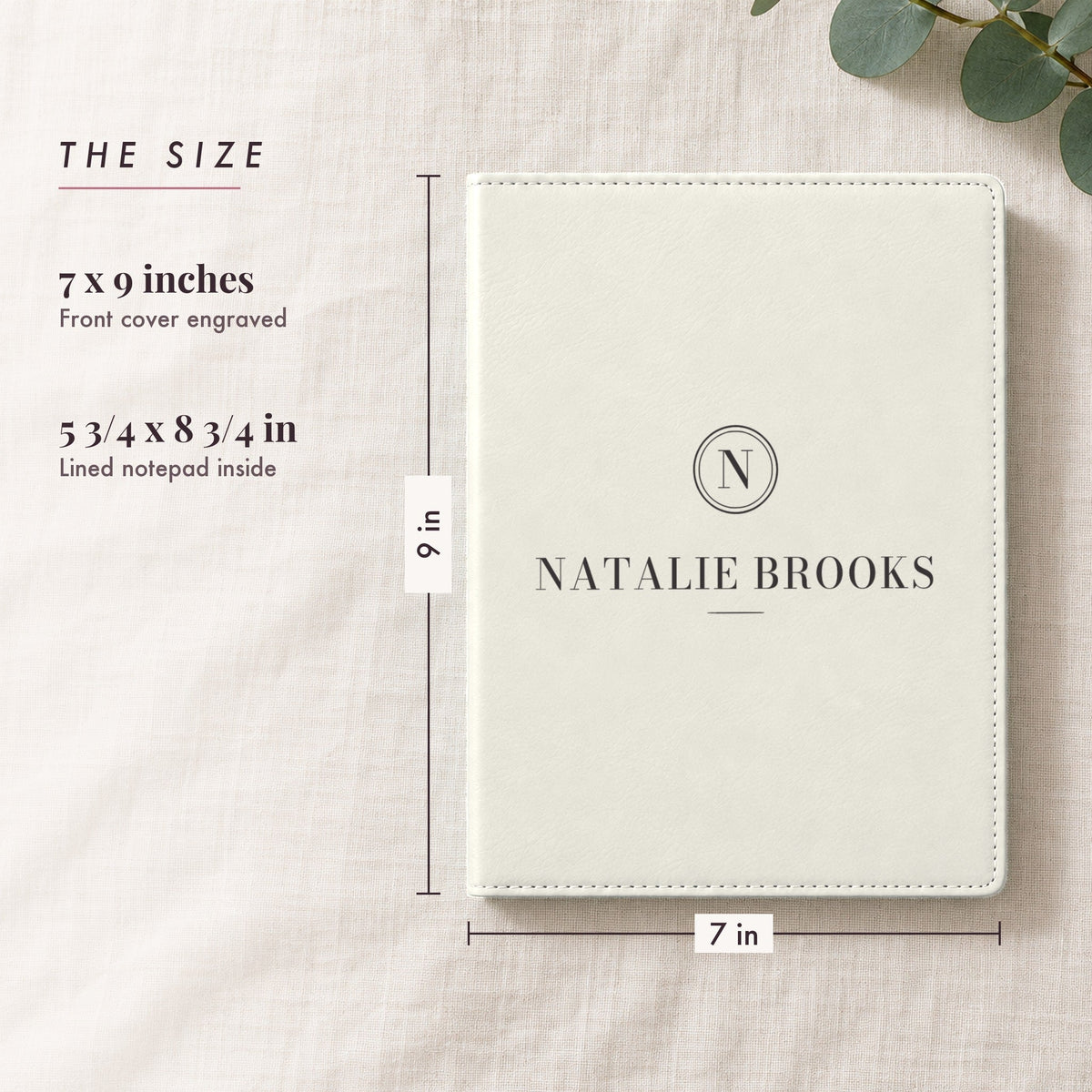 Size of the engraved padfolio, 7 by 9 inches with a 5 3/4 by 8 3/4 inch lined notepad, shown in white with just an N seal and the name Natalie Brooks