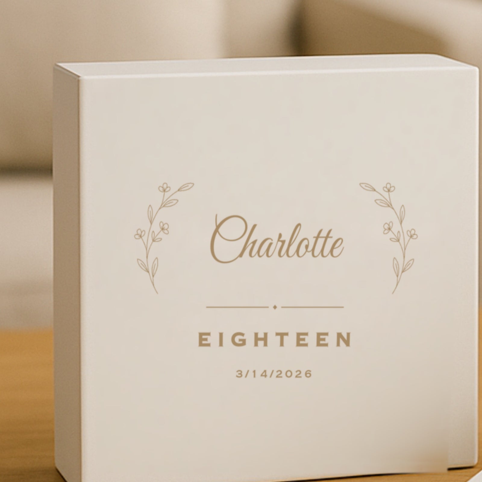 White personalized keepsake box engraved with the name Charlotte in script between two botanical sprigs, above the word EIGHTEEN and the date 3/14/2026.