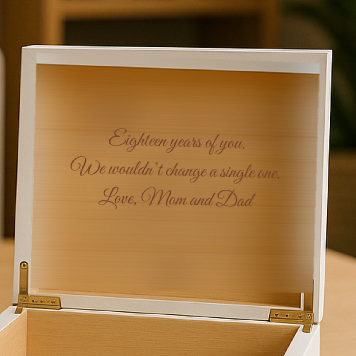 Inside the lid of the personalized keepsake box, a three line family message engraved in script on the Spanish cedar lining of the white box.