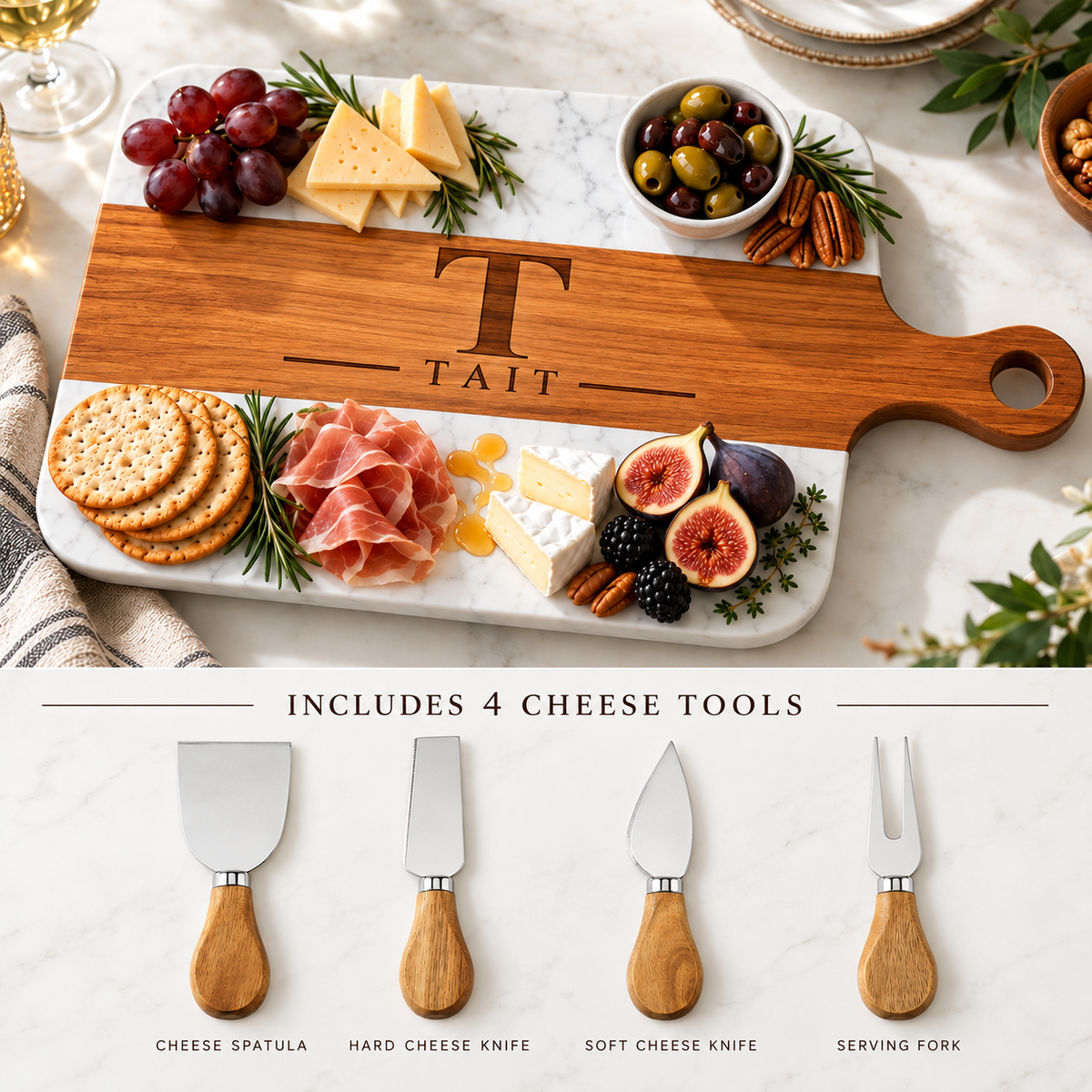 Personalized charcuterie board engraved with initial T and last name Tait alongside the included cheese spatula, hard cheese knife, soft cheese knife, and serving fork.