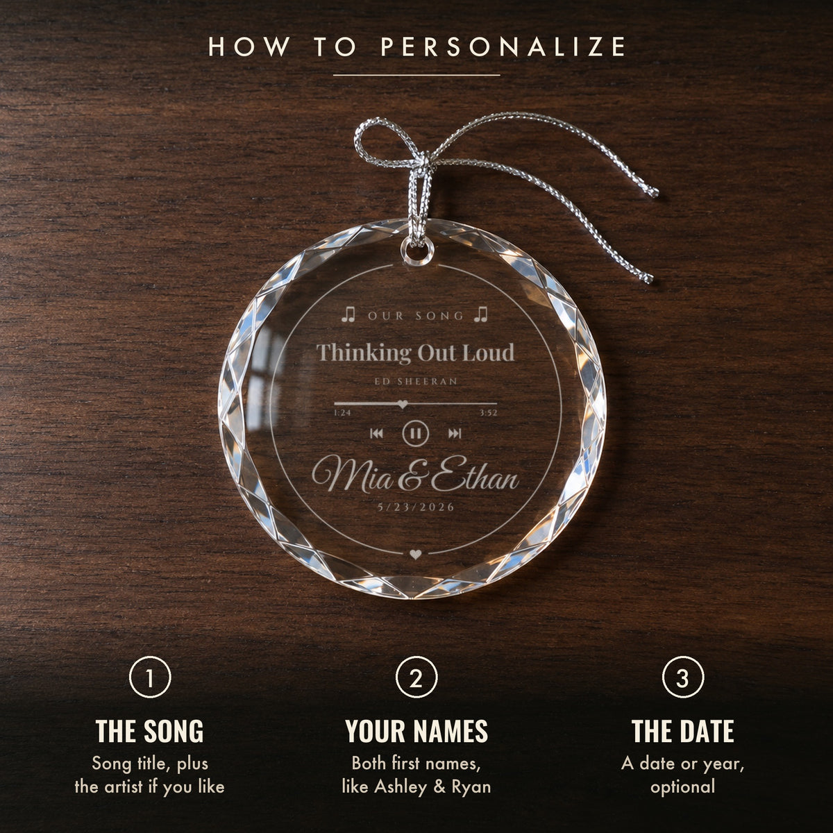 How to personalize the Our Song ornament: 1 the song and artist, 2 your names, 3 an optional date, shown on a walnut table with Mia & Ethan