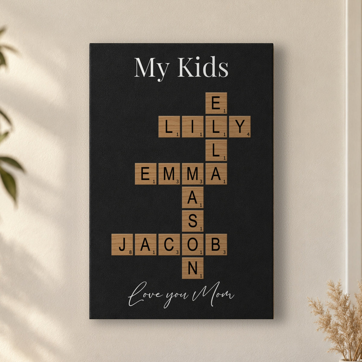Kids crossword sign for Mom: a My Kids sign with her children's names and Love you Mom, hanging on a warm white living room wall above an oak console