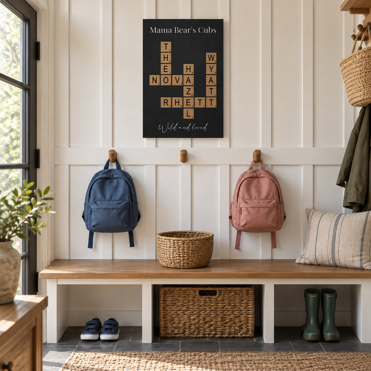 Personalized gift for Mom: a Mama Bear's Cubs crossword sign with her kids' names hanging in a family mudroom above backpacks and hooks