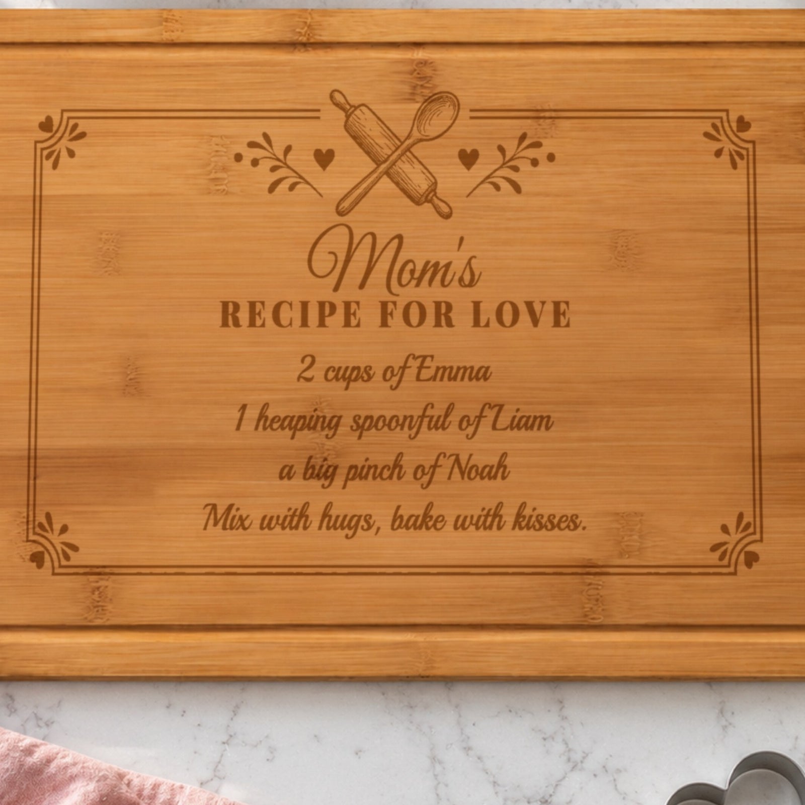Close-up of the laser engraving on the mom recipe board: Mom's Recipe for Love, 2 cups of Emma, 1 heaping spoonful of Liam