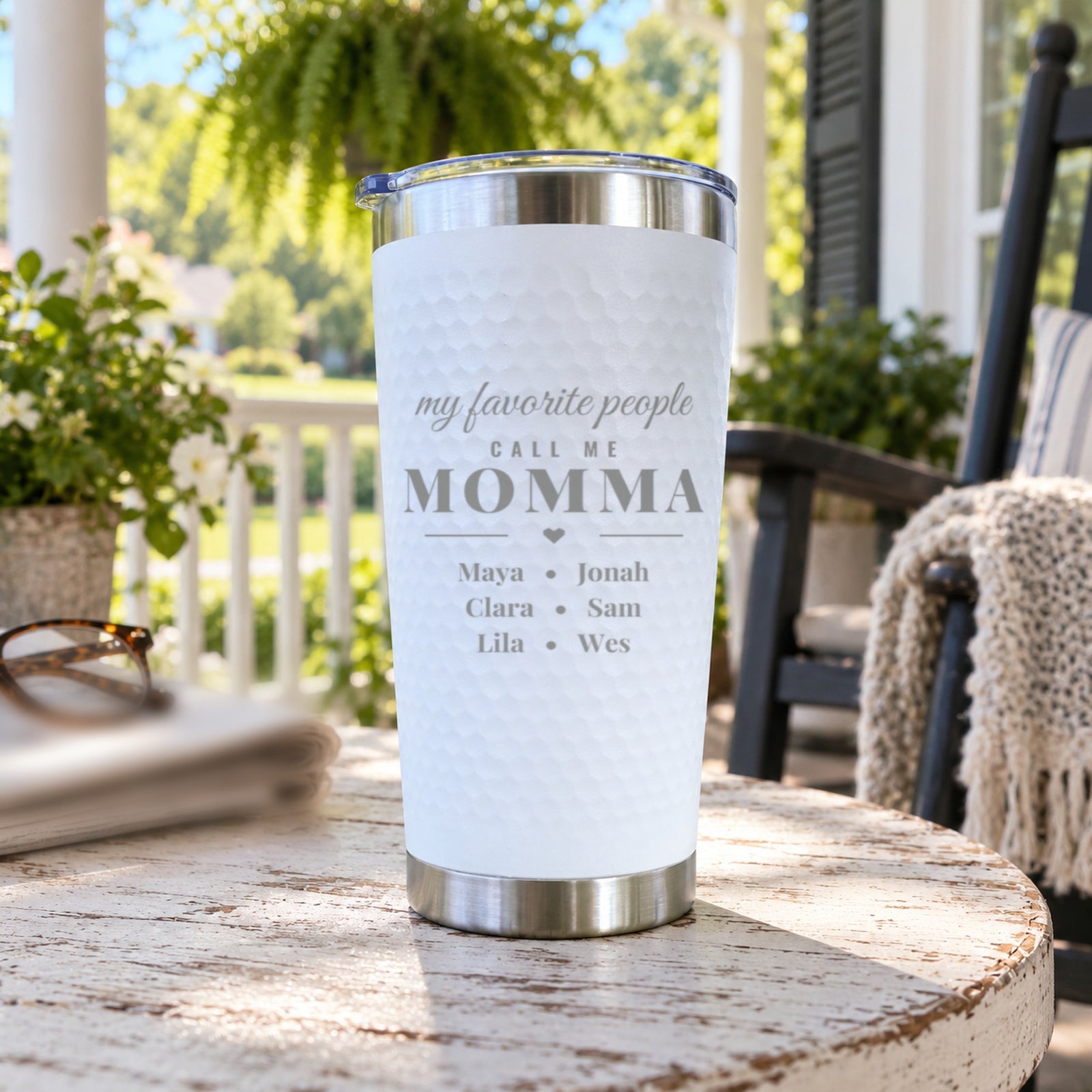 White tumbler engraved my favorite people call me MOMMA with six kids' names in three lines, a gift for a mom of six on a porch