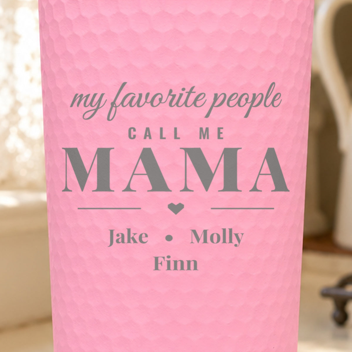 Close-up of the laser engraving on a pink dimpled tumbler: my favorite people call me MAMA with Jake, Molly and Finn below