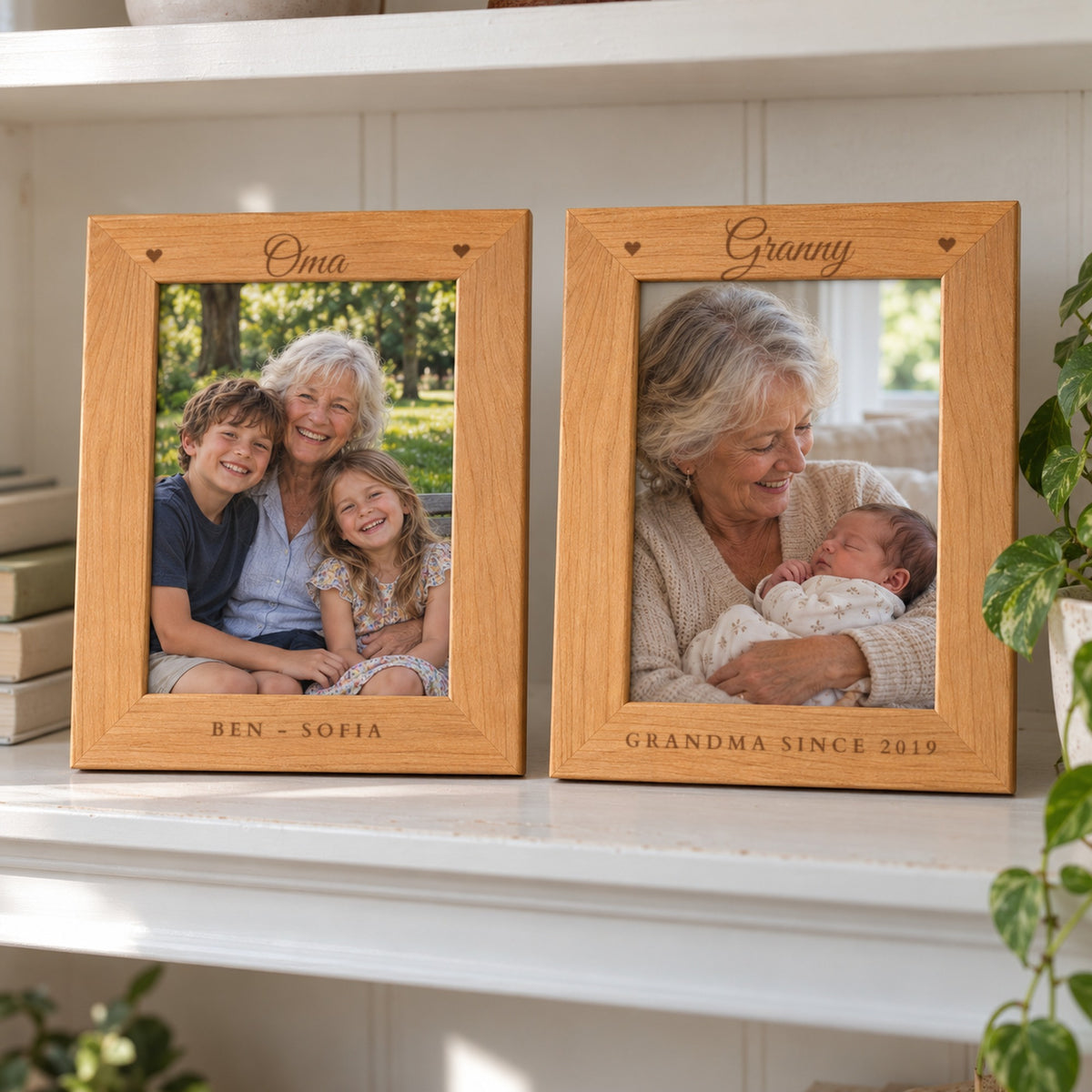 Two engraved grandma picture frames on a bookshelf, one reading Oma with BEN - SOFIA and one reading Granny with GRANDMA SINCE 2019