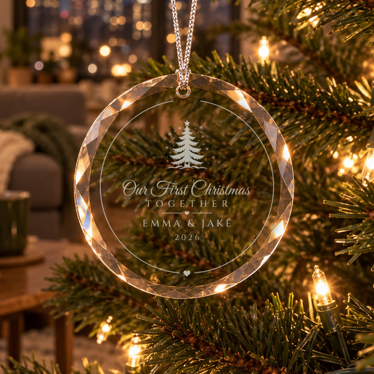 Our First Christmas Together ornament in faceted glass on a lit tree, Christmas Tree design with falling snow, engraved EMMA &amp; JAKE, 2026