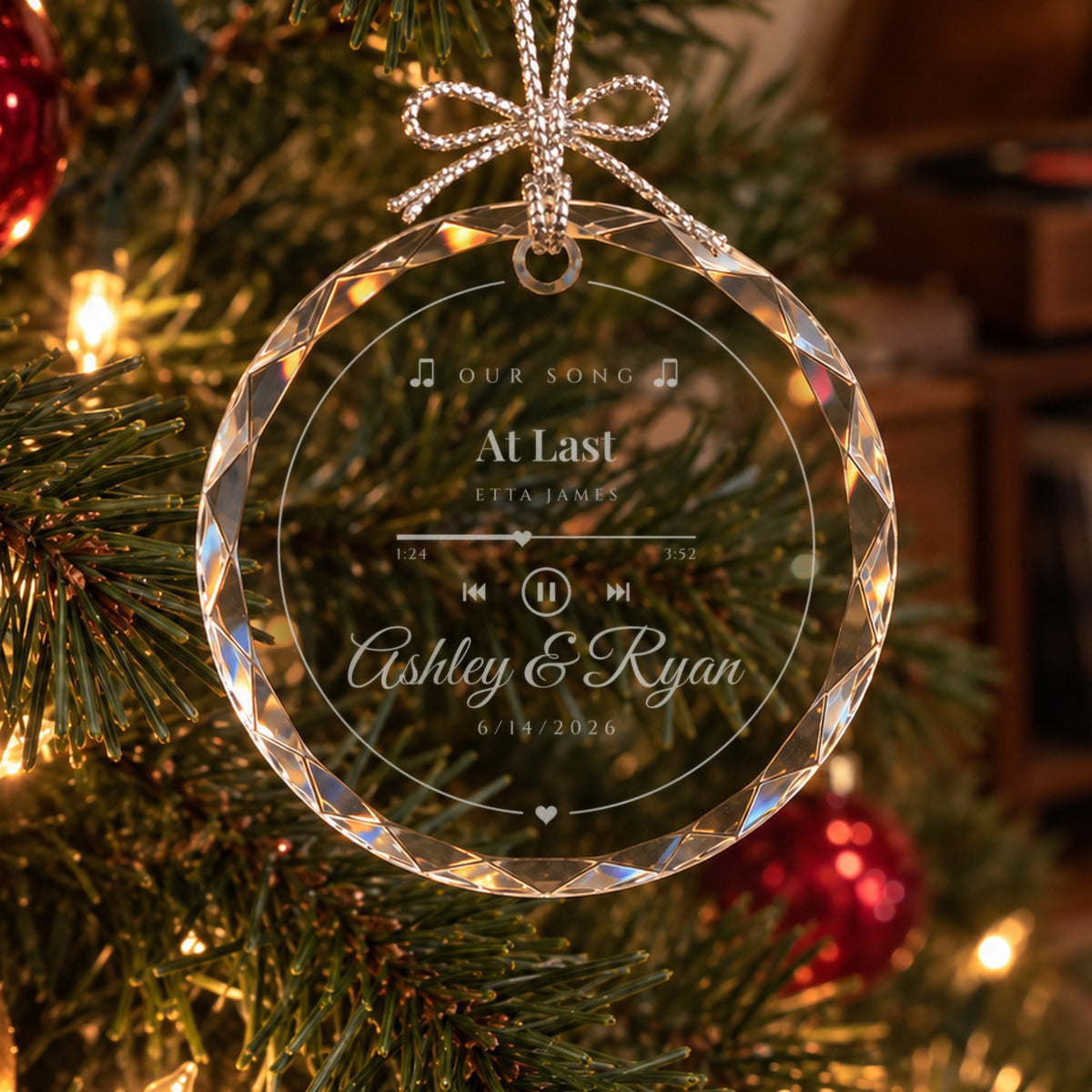 Personalized Our Song glass ornament on a lit Christmas tree, engraved like a music player with At Last, Etta James and Ashley &amp; Ryan
