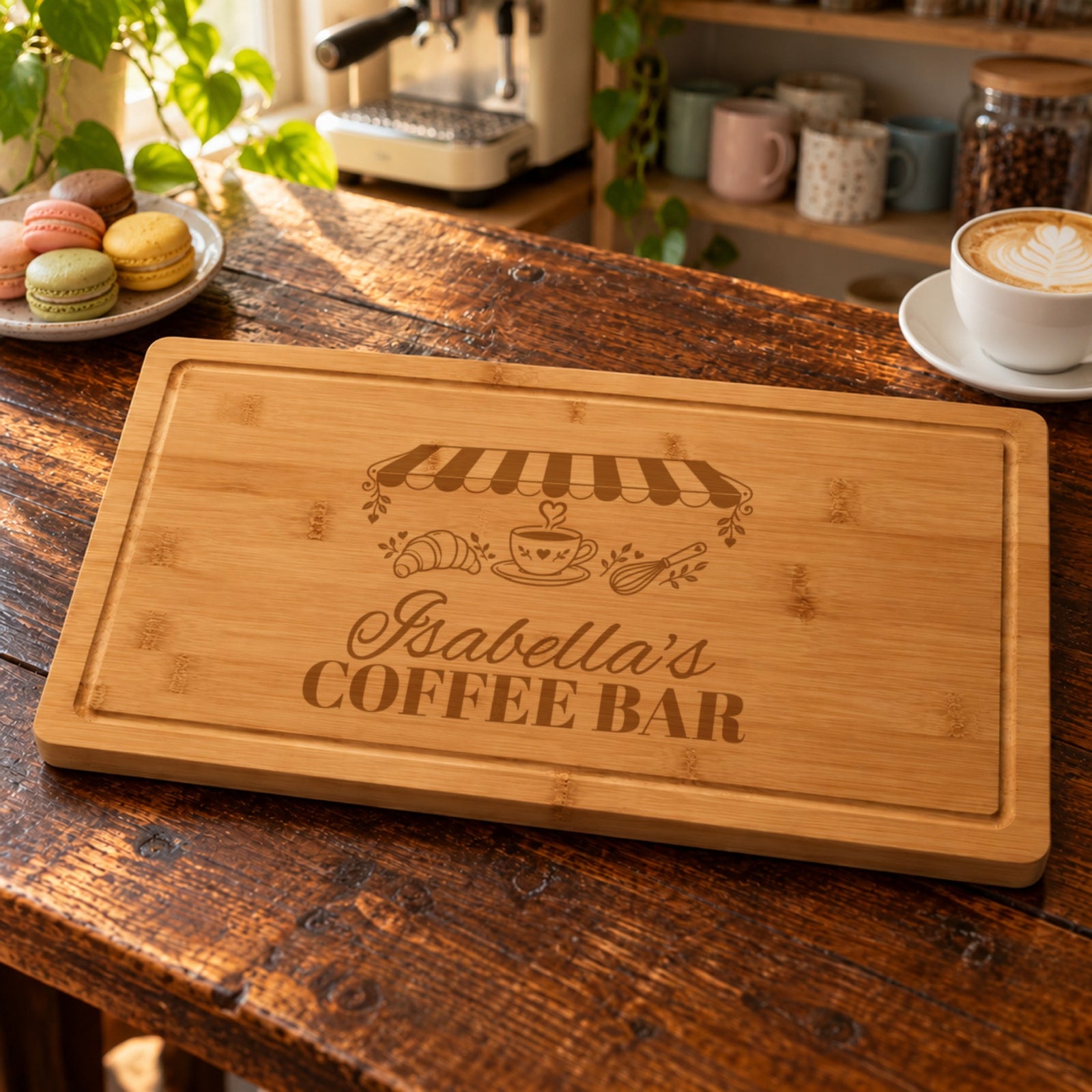 Personalized gift for her: bamboo board engraved Isabella's COFFEE BAR under a striped cafe awning, on a home coffee bar counter with a cappuccino
